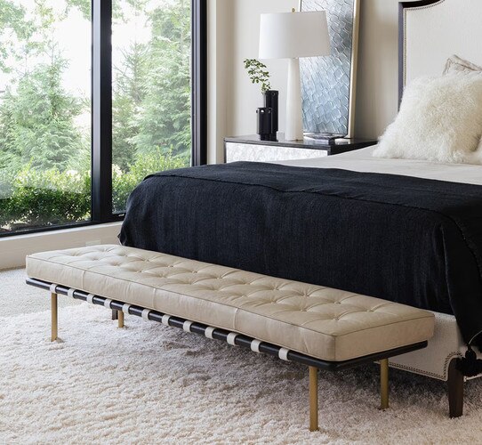 White leather gallery bench at the foot of a bed