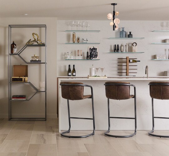 Kitchen island with three leather bar stools and a metal etagere to the left