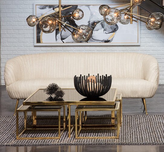 Cream leather sofa in front of a large metal coffee table