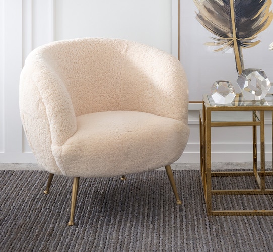 Sheepskin side chair next to a metal side table