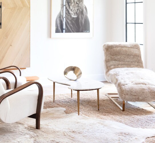 Longhair sheepskin chaise lounge beside coffee table