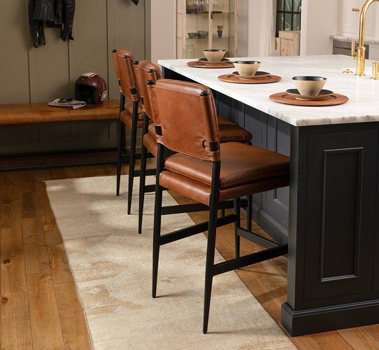 Leather counter chair beside black kitchen island