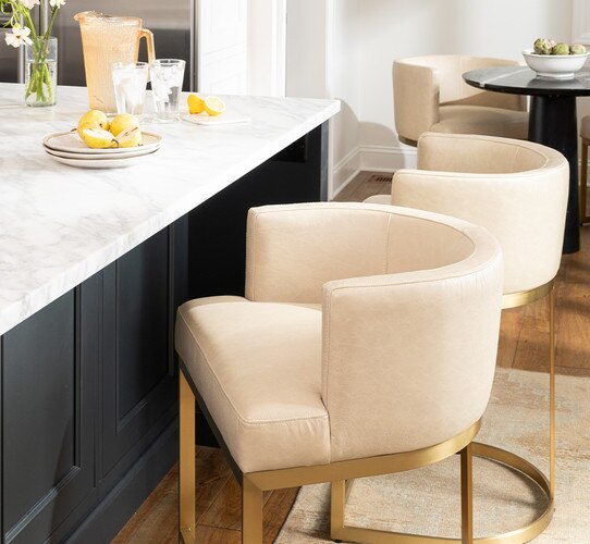 Kitchen island with white and brass counter stools