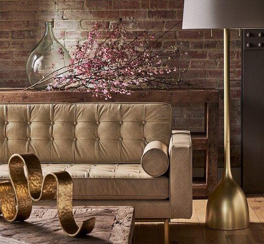 White leather sofa behind a wood coffee table