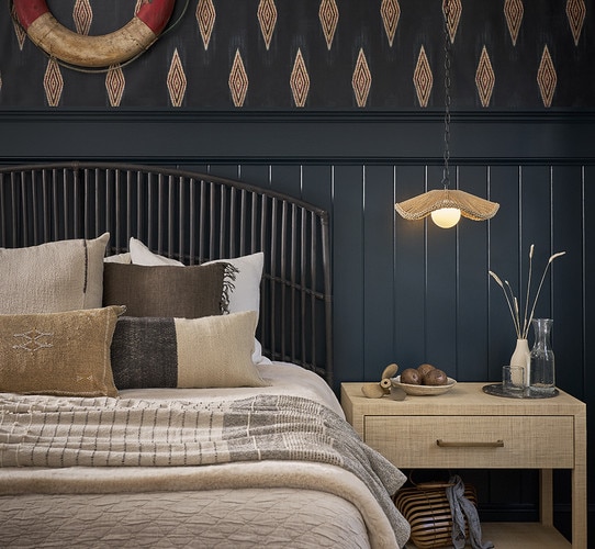 Black bed frame with two side tables holding lamps