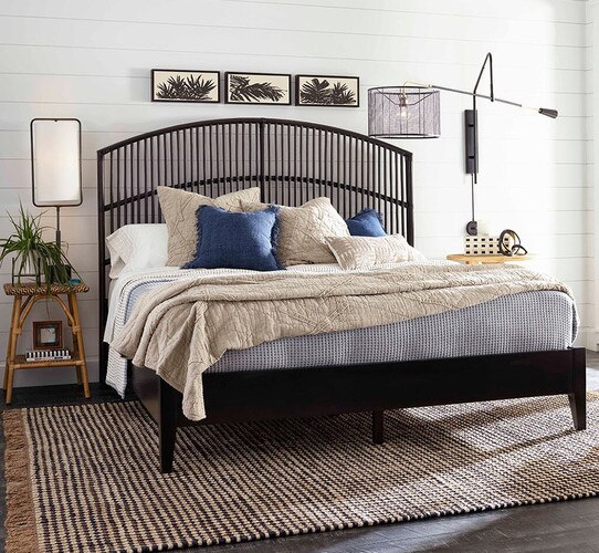 Black bed frame with two side tables holding lamps