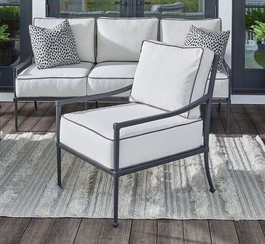 Black framed outdoor chair sitting on a rug
