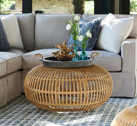Rattan coffee table beside a gray sofa
