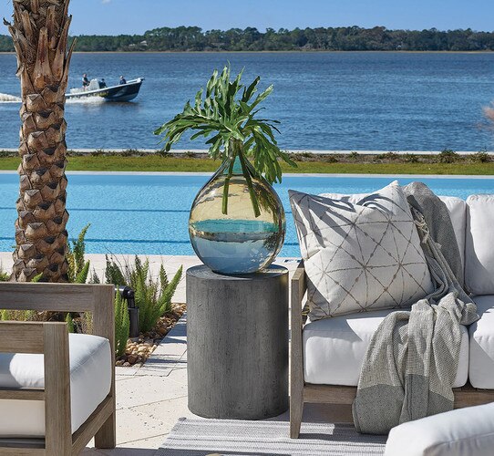 Cylindrical side table next to an outdoor sofa