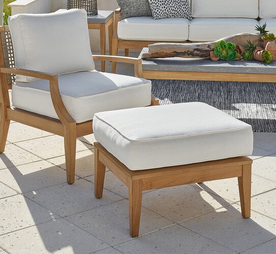 Wood ottoman beside an outdoor wooden chair