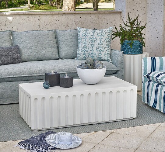 Outdoor patio with a white concrete coffee table sofa and chair
