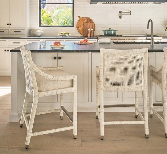 White rattan chairs at a kitchen island