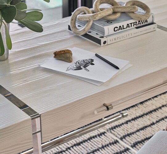 Desk holding books and a drawing of a manatee