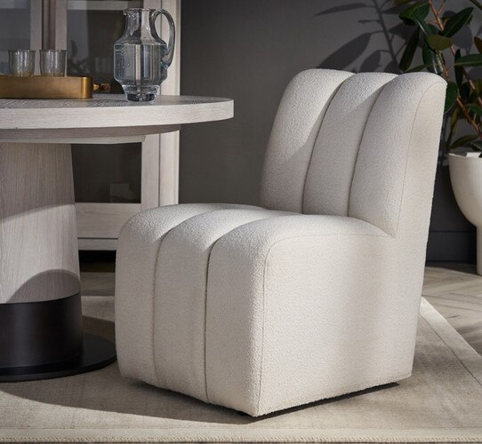 Fabric side chair beside a white dining tab