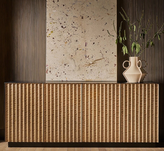 Wood Credenza holding a large vertical abstract painting