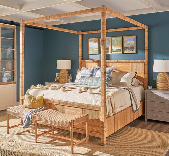 Wicker poster bed in a blue bedroom with gray nighstands