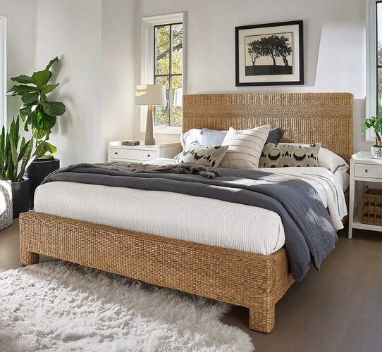 Rattan bed frame with two white wood nightstands