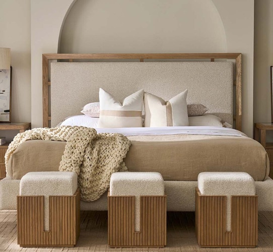 Bed with three wood and fabric stools at the foot