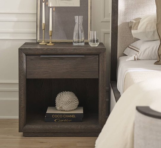 Wood nightstand with sculputures and books on the bottom shelf