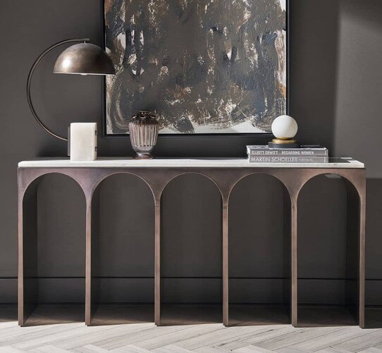 Metal console table with aqueduct like arches below a painting