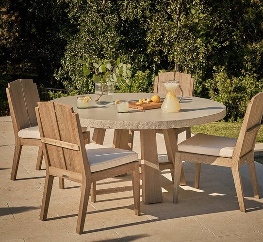 Stone and wood outdoor table surrounded by four wood chairs