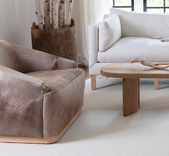 Hair on hide swivel chair beside a wood coffee table
