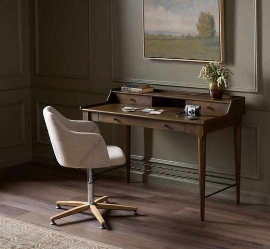 Traditional wooden desk under a landscape painting of a field