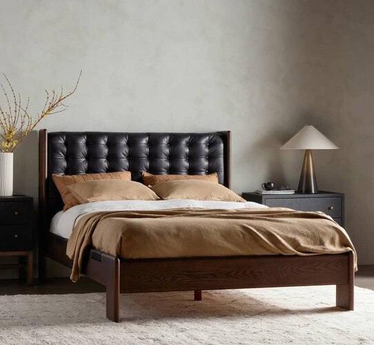 Black leather and wood bed frame with white and brown covers