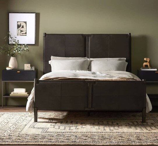 Black leather bed with white linen pillows and covers