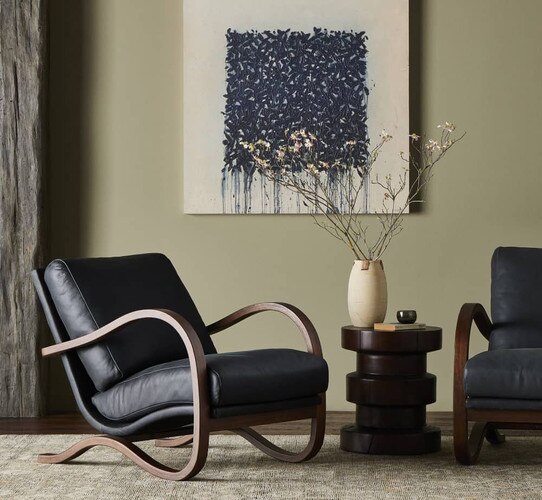 Black leather and wood chairs beside a wood side table