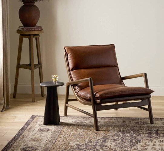 Leather and wood chair beside a small side table holding a martini