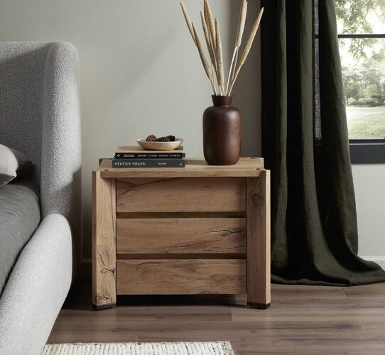 Wood nightstand holding a large brown vase with stalks