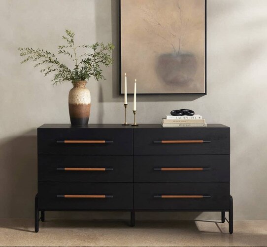 Six dresser black dresser below a neutral painting