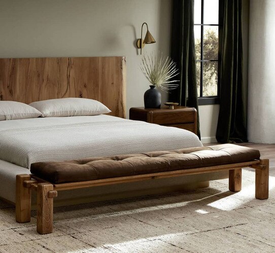 Leather and wood bench at the end of a bed