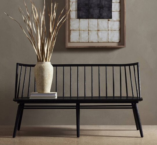 Wood bench holding a white vase