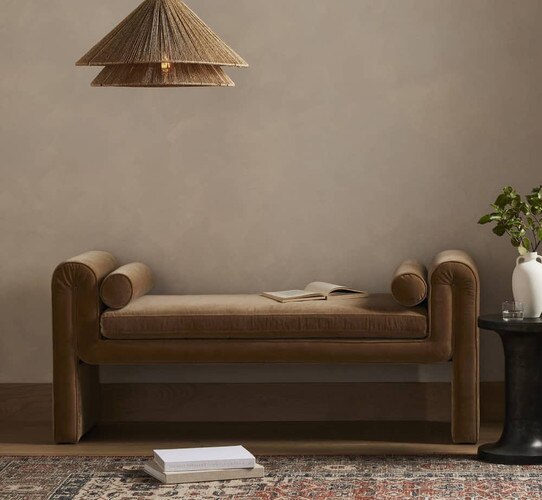 Felt day bed under a wicker pendant