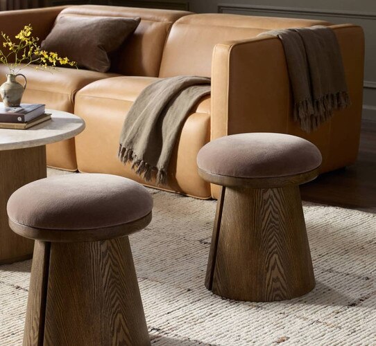 Wood and maroon stools beside a leather sofa