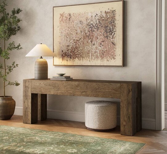 Wood credenza below a large abstract painting