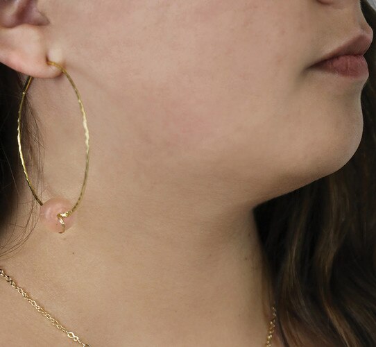 Gold hoop earring with pink stone