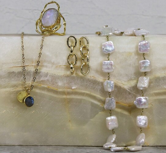 Gold jewelry draped over a stone