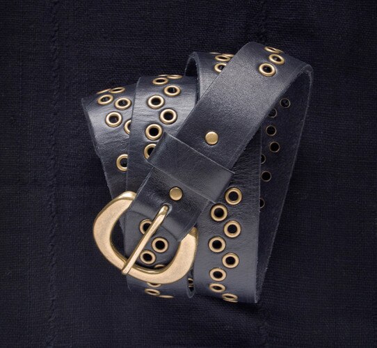 Leather belt with brass buckle and interspersed brass buckle holes