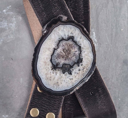 White agate belt buckle on a black leather belt