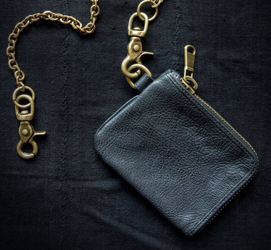 Black leather coin purse with a brass chain