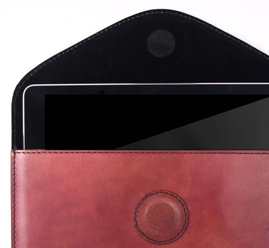 Red leather ipad case with an ipad in it