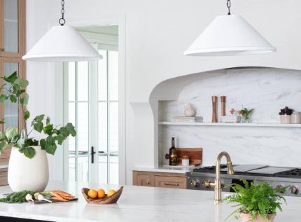 dark bar room with three lit sconces and shelves