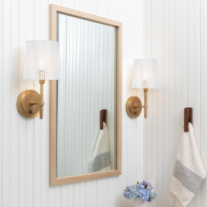 bathroom mirror with two brass sconces on each side