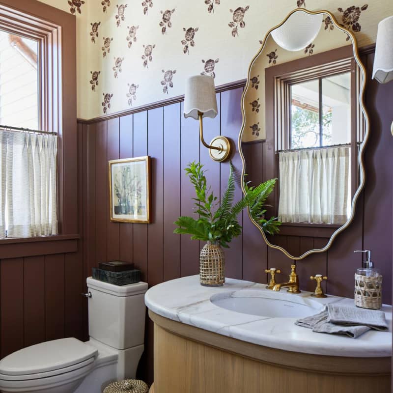 bathroom mirror with two brass sconces on each side