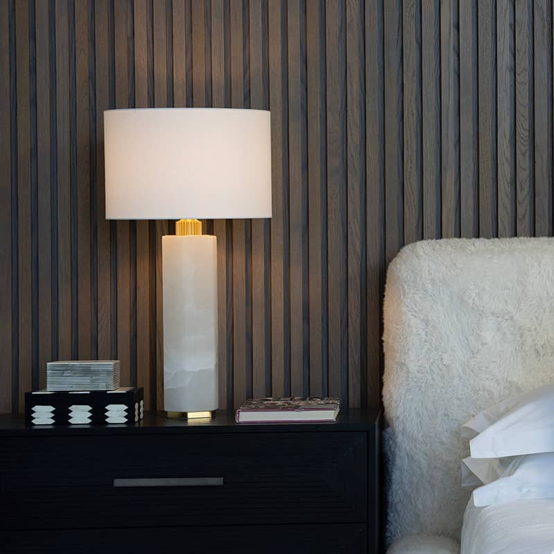 bedroom lamp on side table with a white bed