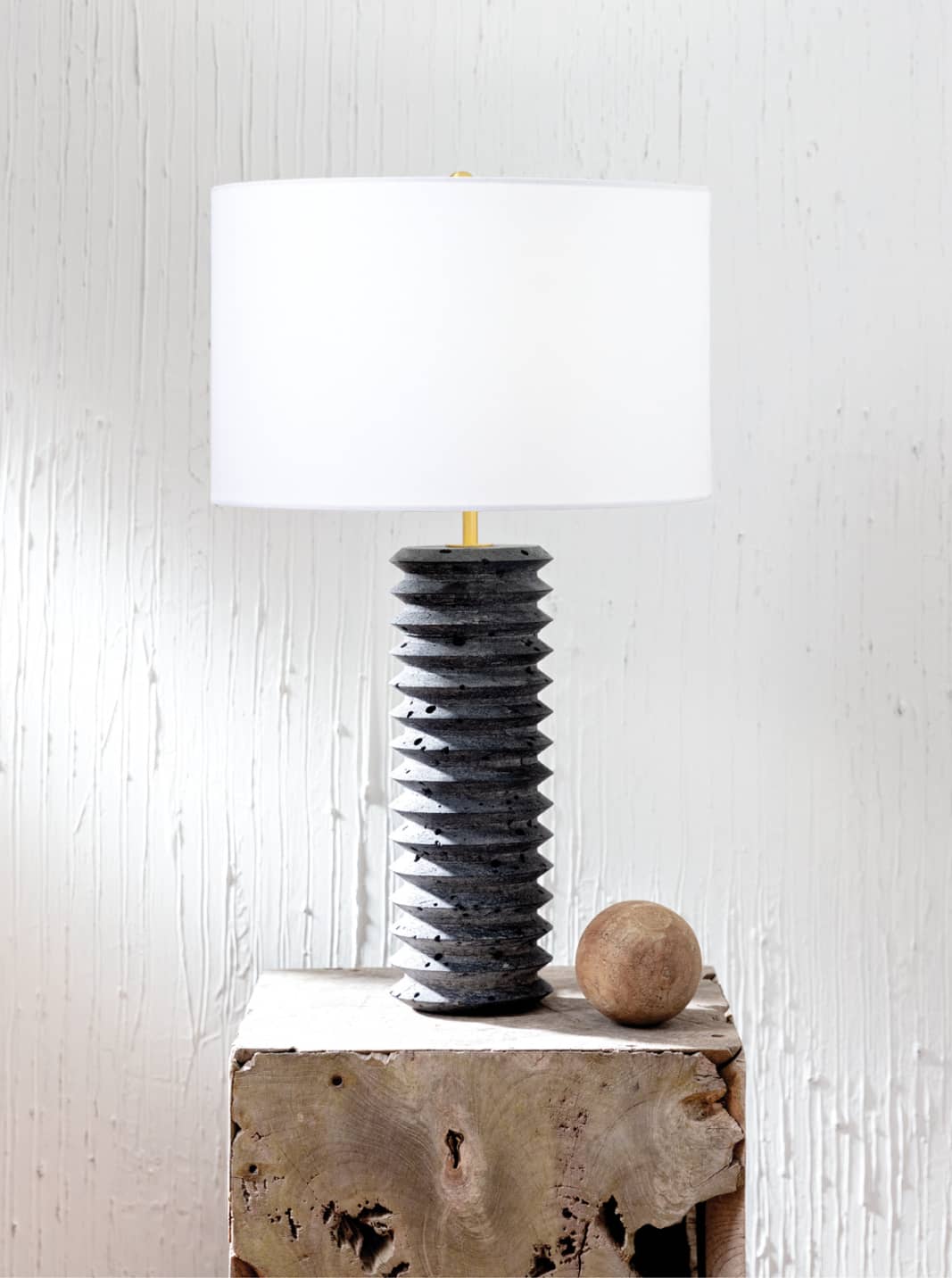 black tourmaline lamp on top of a natural wooden side table