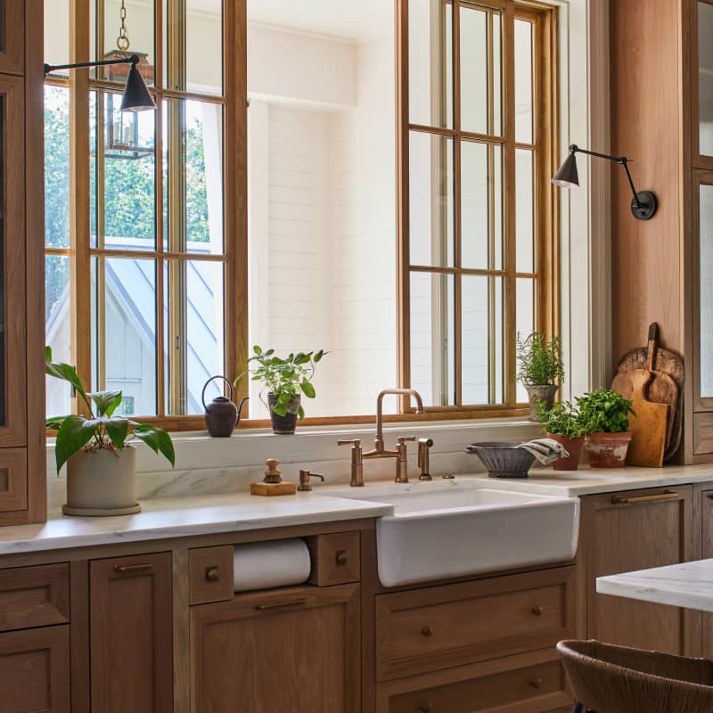 wooden pendant lights above a white marble kitchen island